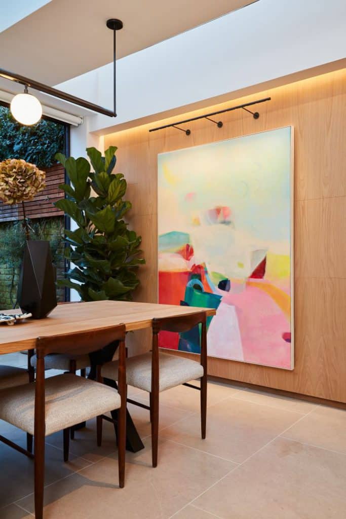 A natural wooden panelled wall in a kitchen dining room.