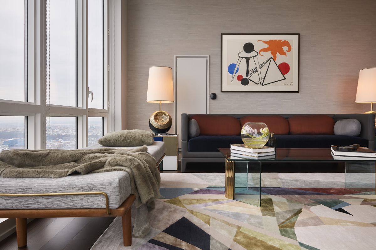 A silk rug grounds this living room with jewel tones to compliment the Alexander Calder art hanging above the sofa. 