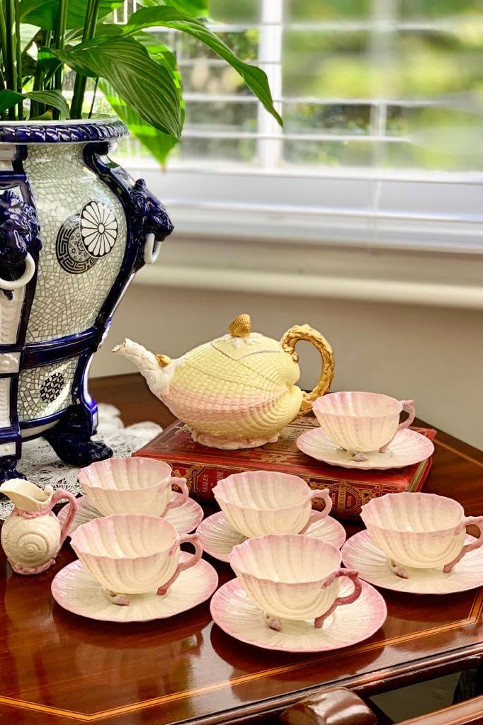 Belleek porcelain Neptune shape teacups, c.1900, with a Brownfield clam shaped teapot, c.1880.