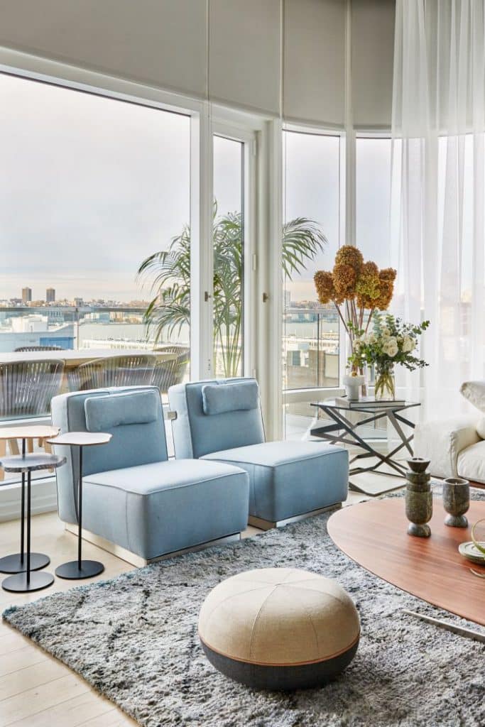 A pair of blue ABC armchairs sit on top a silk rug from Stark rugs.