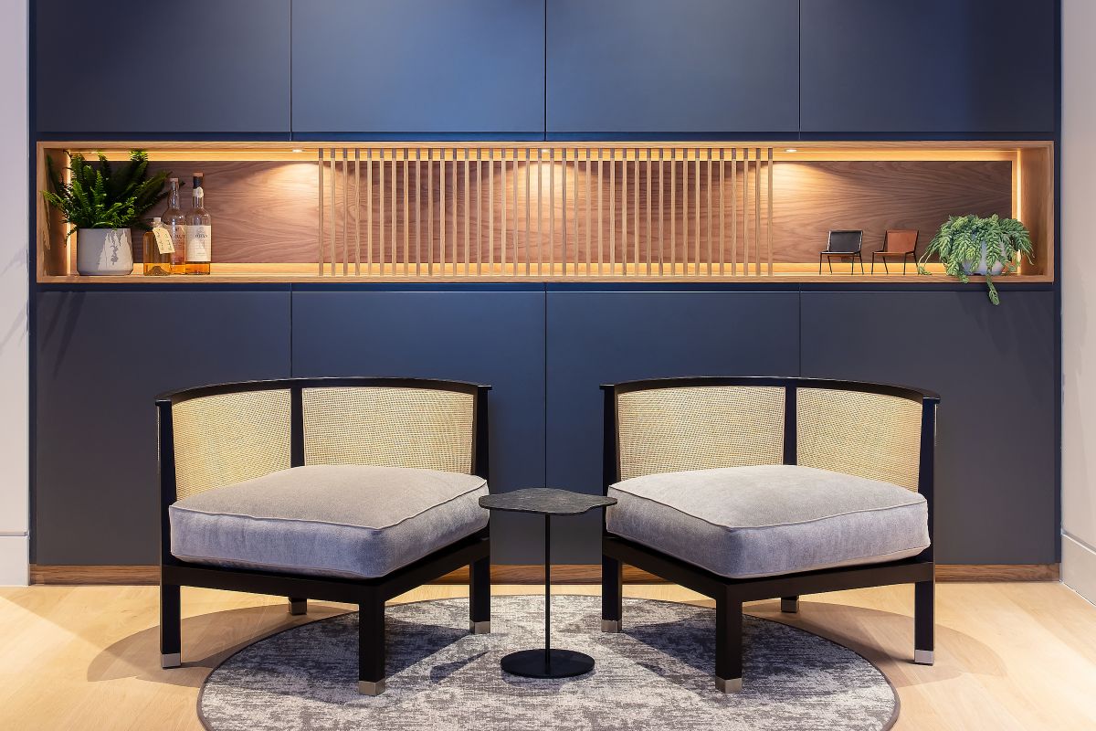 A pair of flexform rosetta armchairs create a reading area in the library corner of this living room. 