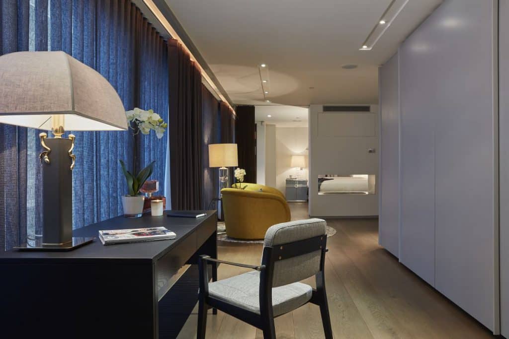 A black leather desk creates a quiet study areas in the master bedroom.