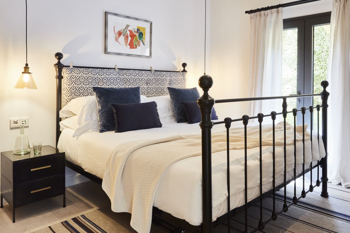 A traditional cast iron bedstead in light and airy holiday villa Alcudia Mallorca. 