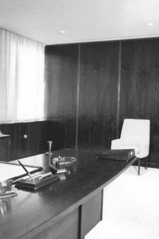 A mid century black and white photo of an office. 