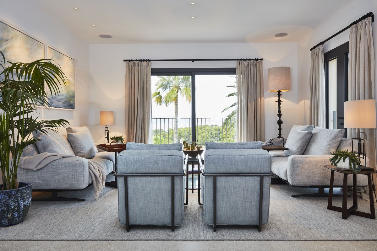 A modern mallorcan villa living room interior with natural stone and sea views. 