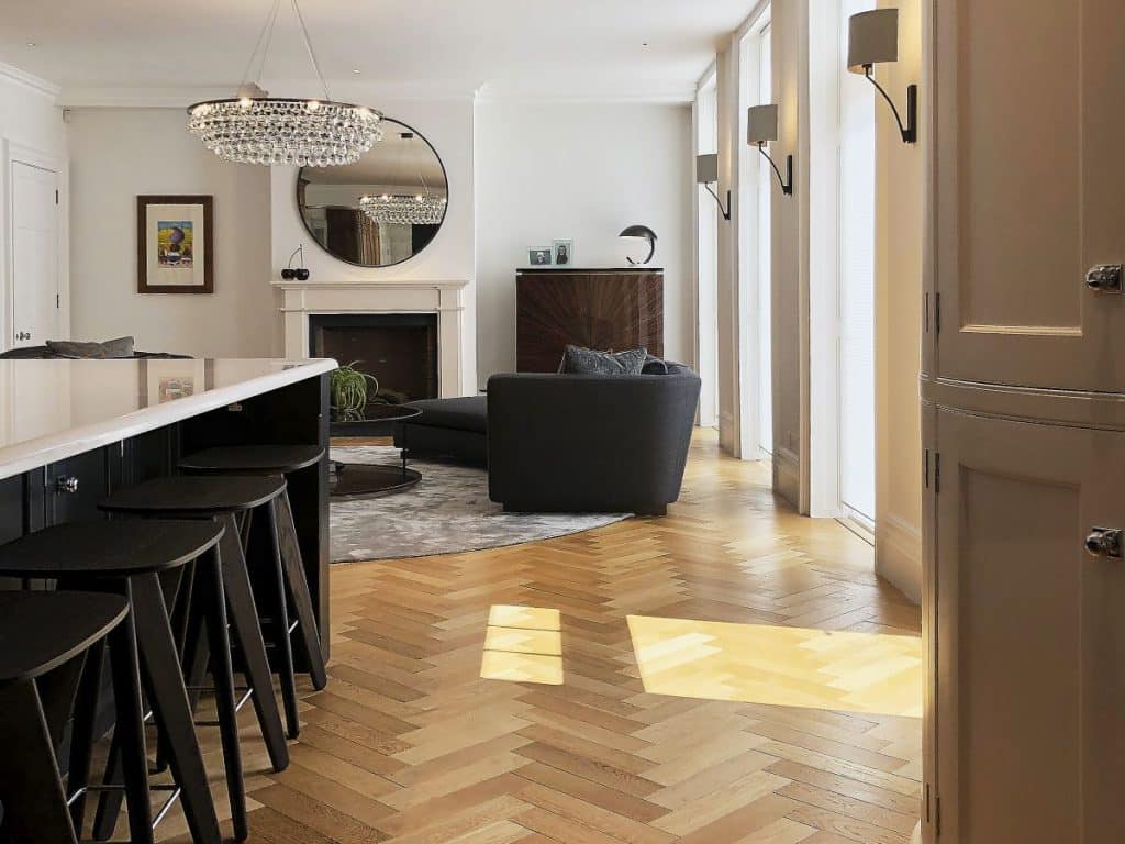 An Arctic Pear Chandelier by Ochre creates a focal point in this living room.