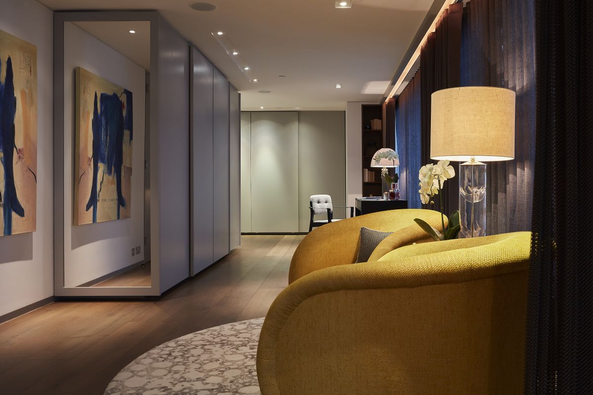 A pair of yellow upholstered bucket armchairs. 