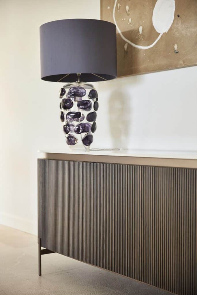 A porta romana blob lamp in denim colour on console table.