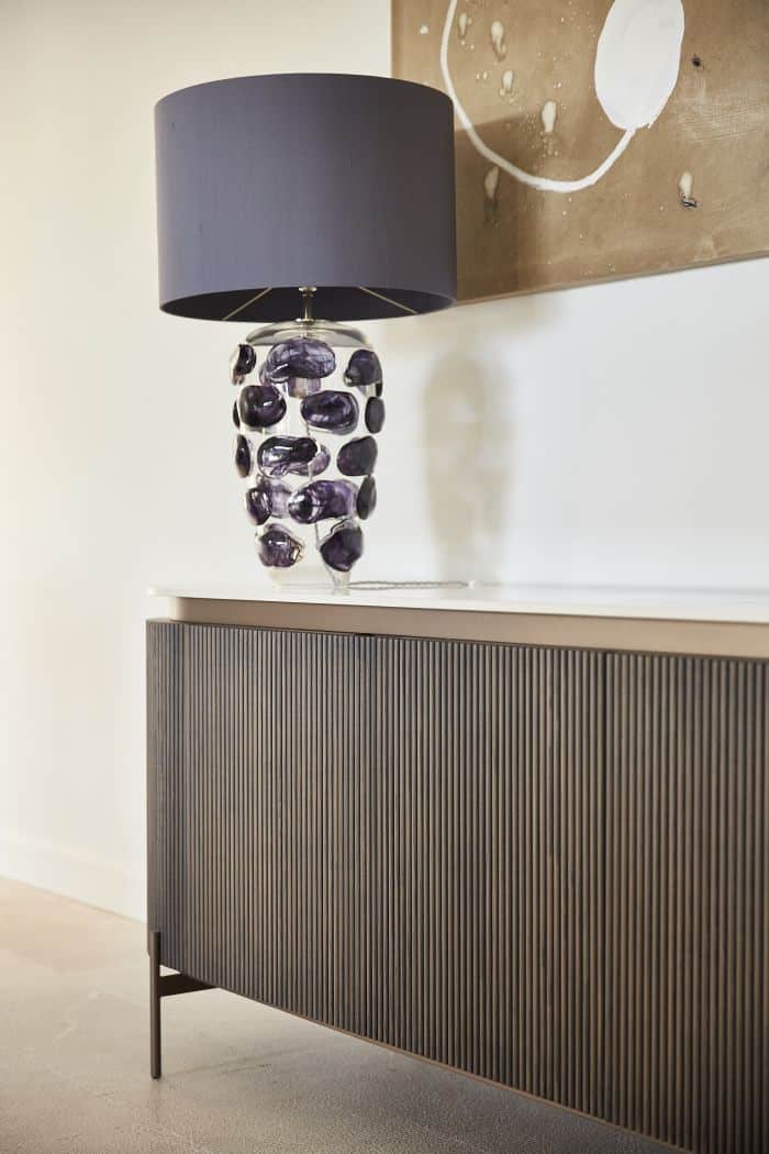 A porta romana blob lamp in denim colour on console table. 