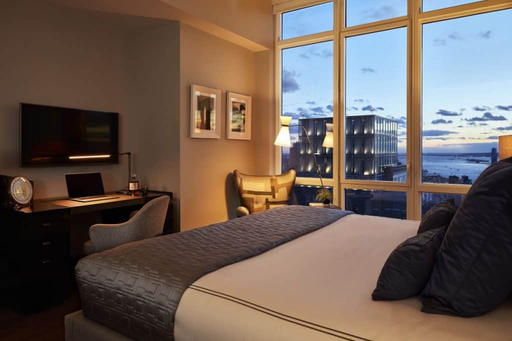 Master bedroom with seating and study area in NYC Penthouse.