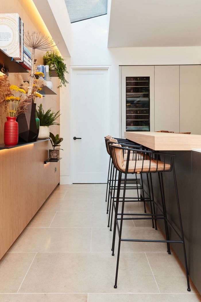 Metal barstools at bulthaup kitchen bar counter on British Limestone floors. 