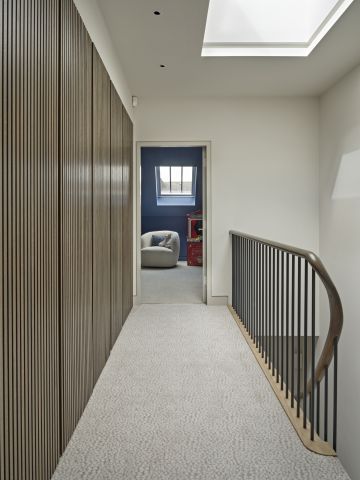 Elegant London home hallway and staircase with build in cabinetry.