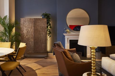 Luxury dark blue living room in London Apartment. The living are is Eclectic style.