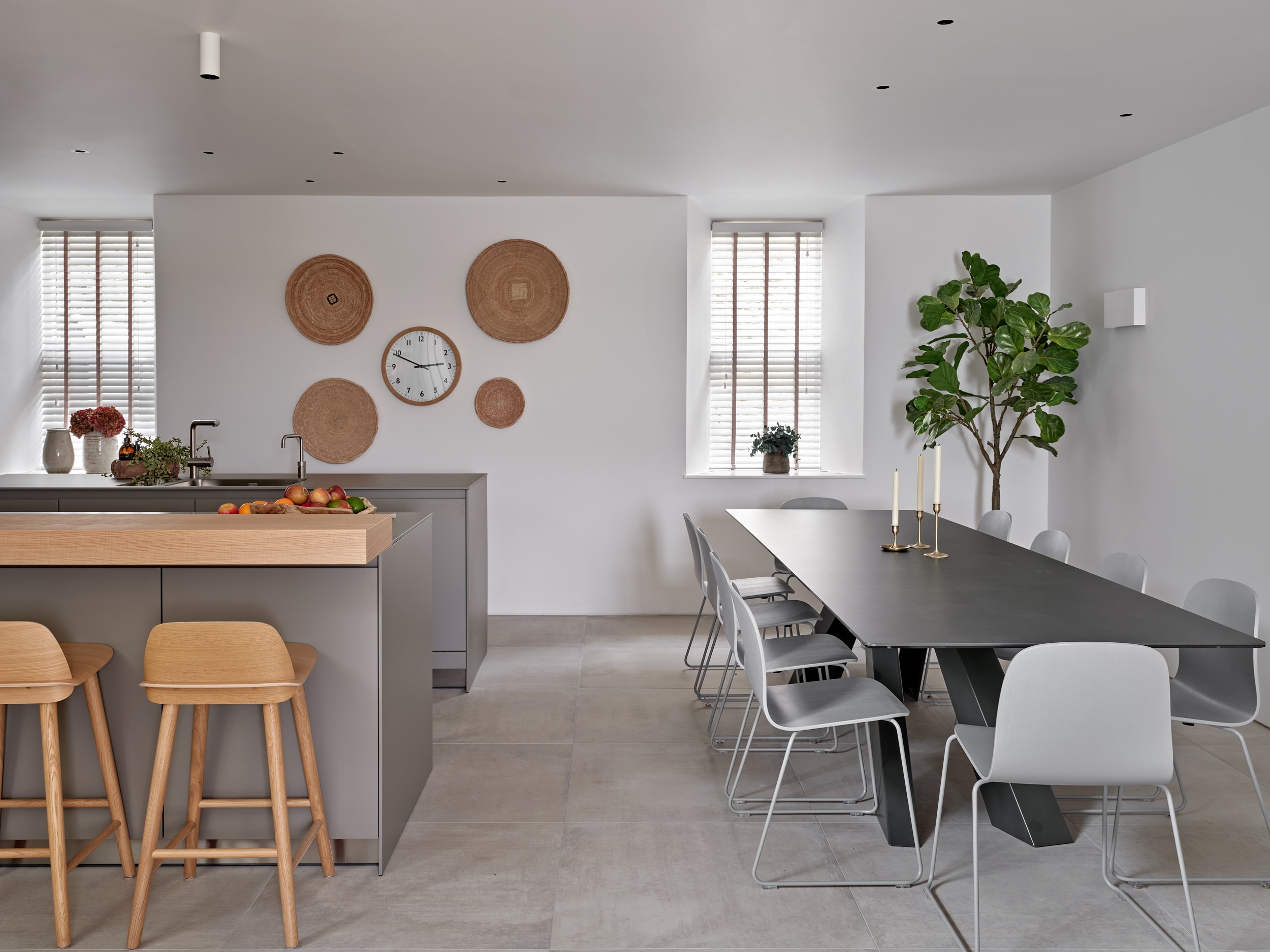 Open plan neutral minimalistic kitchen and dining space.