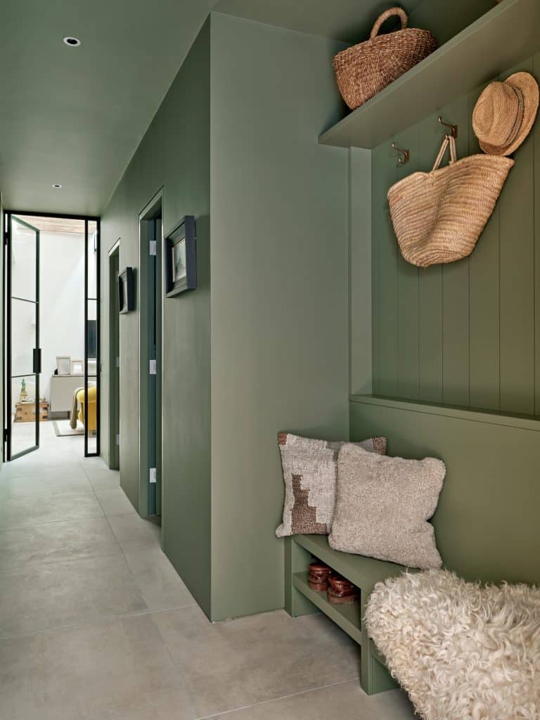 Sage green hallway in coastal style house.