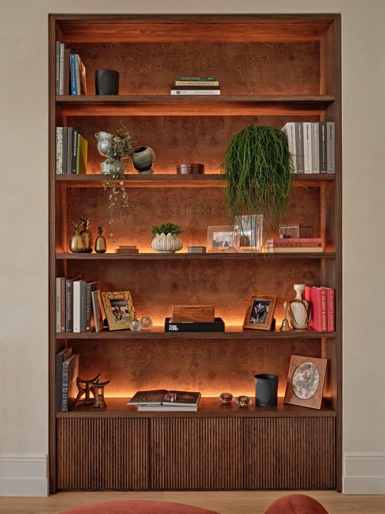 Wooden bespoke joinery in Central London flat. The joinery is lit up from the back to give a warmer and cozier mood.