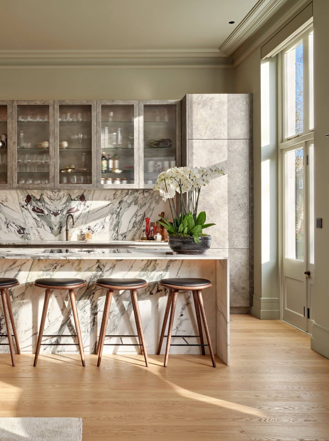 Marble kitchen island in open plan kitchen area.