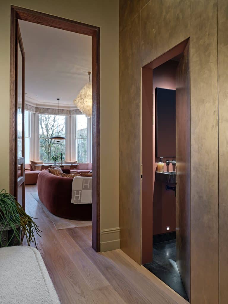 Entry from hallway to either the living room or to the guest bathroom in central London apartment.