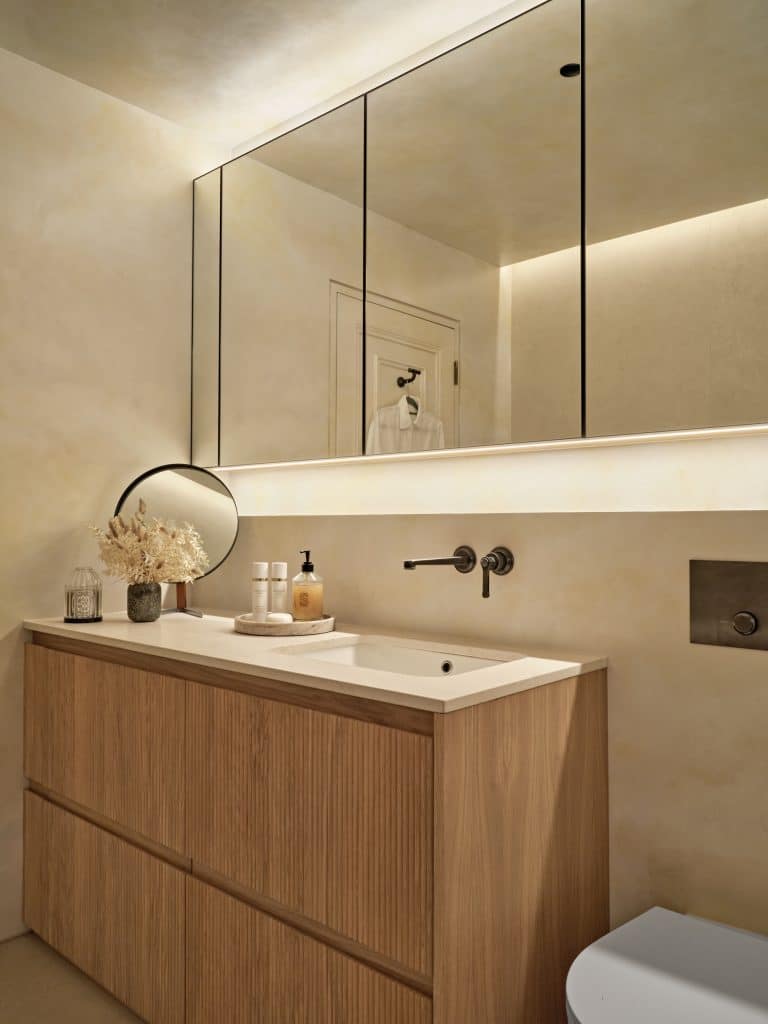 Countertop and cabinetry in neutral relaxing bathroom.