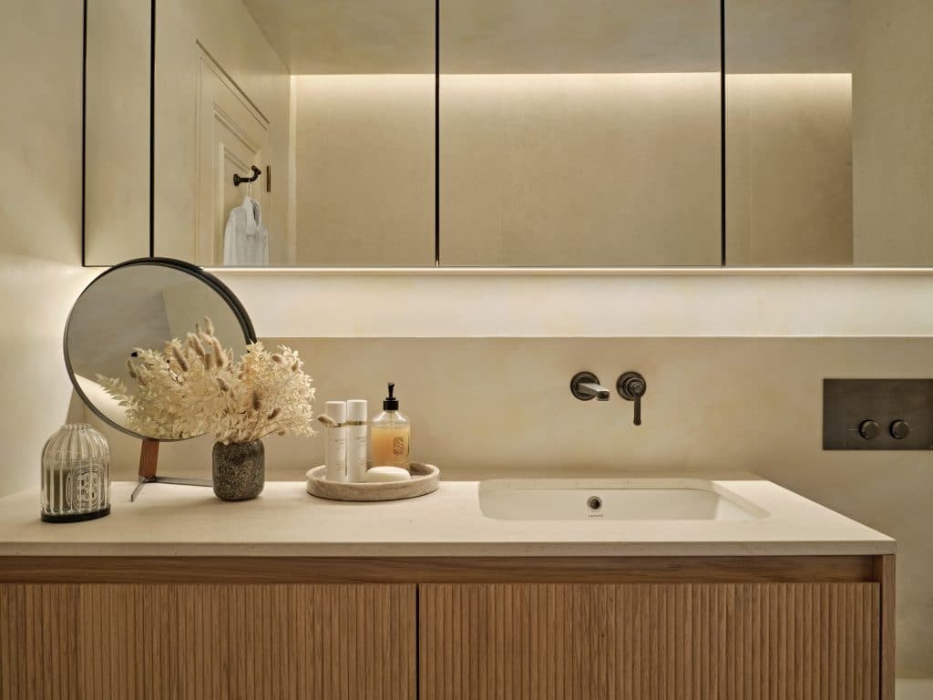 Countertop and cabinetry in neutral relaxing bathroom.